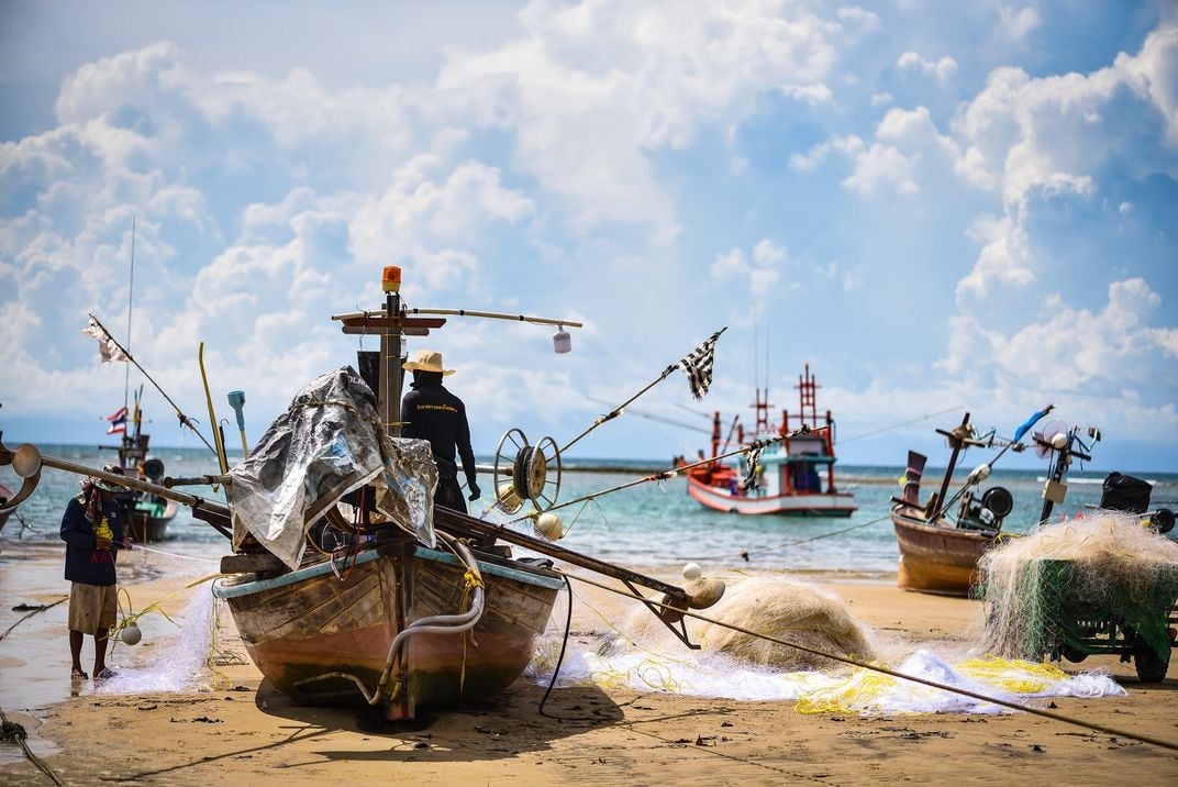 11 - Fishermen prepare to launch into the sea on a cloudy, yet sunny, day.