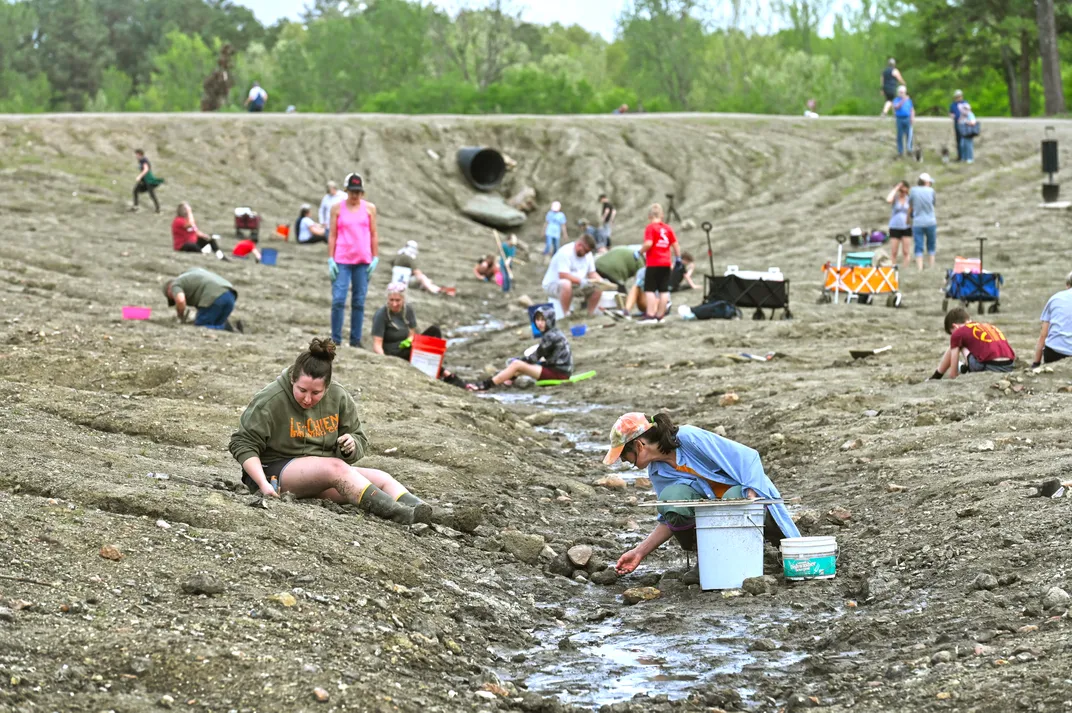 People sitting on the ground and digging