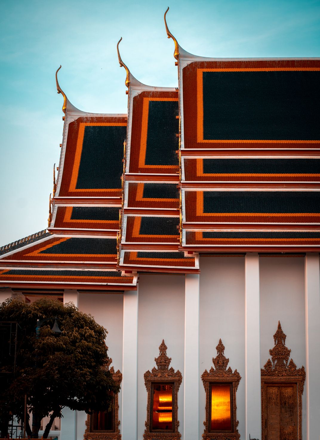 4 -Golden ornamentation accents the colorful and intricate roofing of Wat Pho, a centuries-old temple.