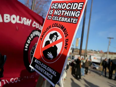 Signs calling for the abolition of Columbus Day formed the backdrop for a protest in front of city hall in Flagstaff, Arizona.