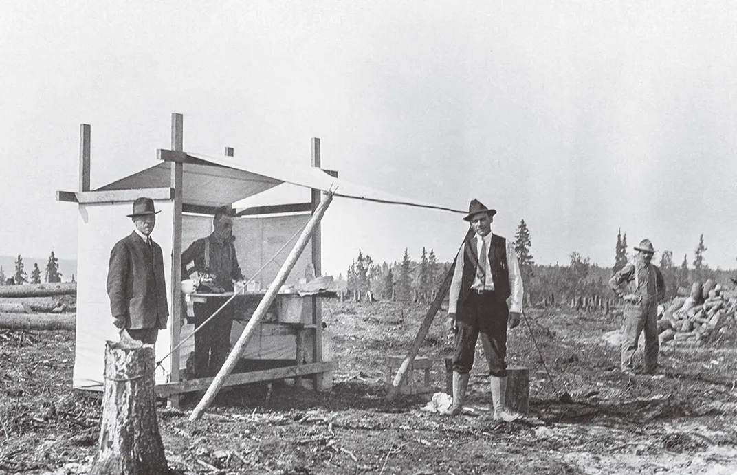 a black and white photo of workers in Alaska taking a break at a lemonade stand