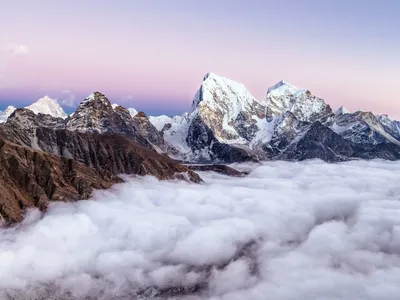 Just before sunset, the peaks of Gokyo Ri in Sagarmatha National Park peek through the clouds.