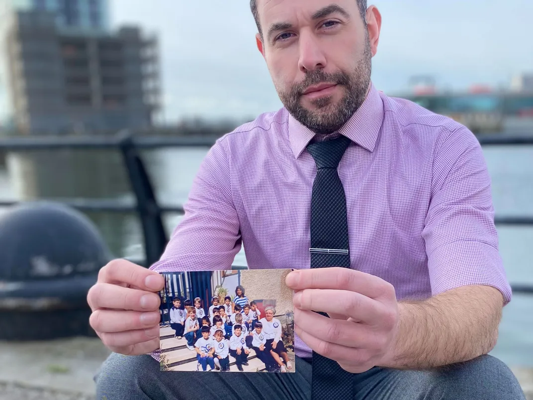 David Rubin holds a photograph of his grandmother, Perl, and himself as a kindergartener.