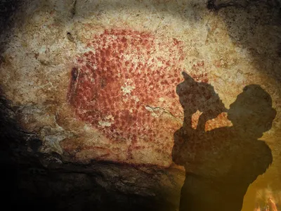 Artist's rendering of a prehistoric human playing the ancient conch instrument