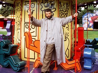 Luna Luna&#39;s creator,&nbsp;Andr&eacute; Heller, stands on a merry-go-round designed by Keith Haring in June 1987.