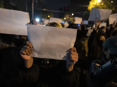 Protesters in Beijing hold up white sheets of paper during a November 27 protest against China&#39;s strict zero-Covid policy.