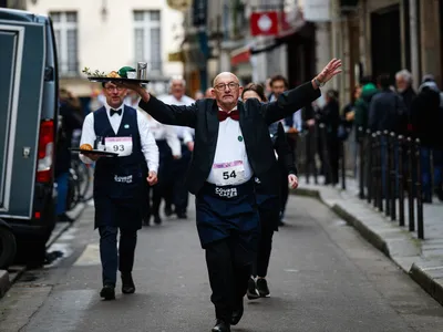 Waiters walked quickly through the streets of central Paris on Sunday while carefully balancing a tray on one hand.

