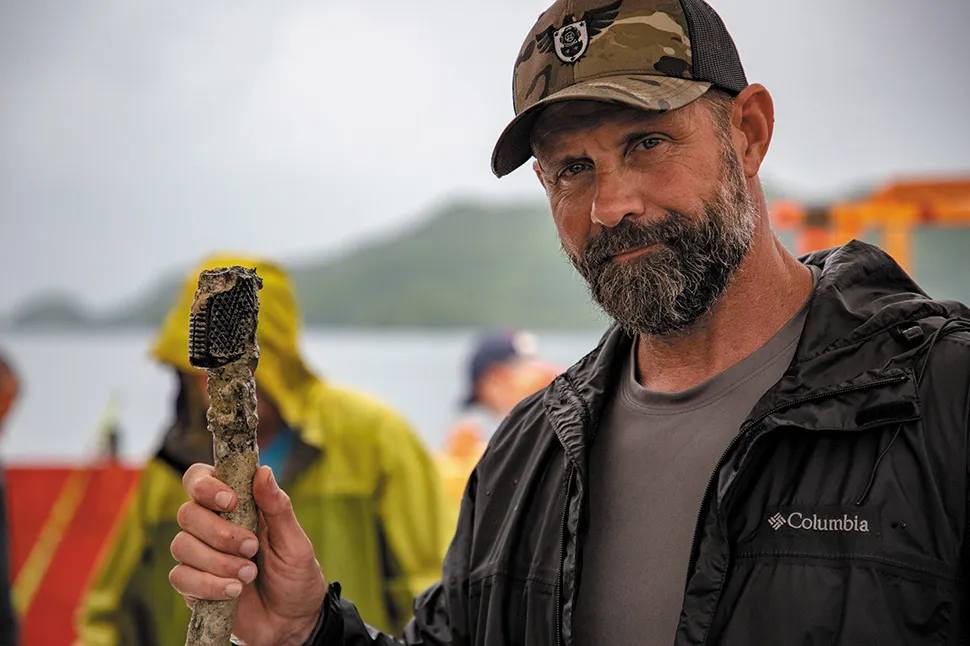 John Marsack, of Legion Undersea Services, holding newly recovered plane parts, including Manown’s control stick— a significant discovery.