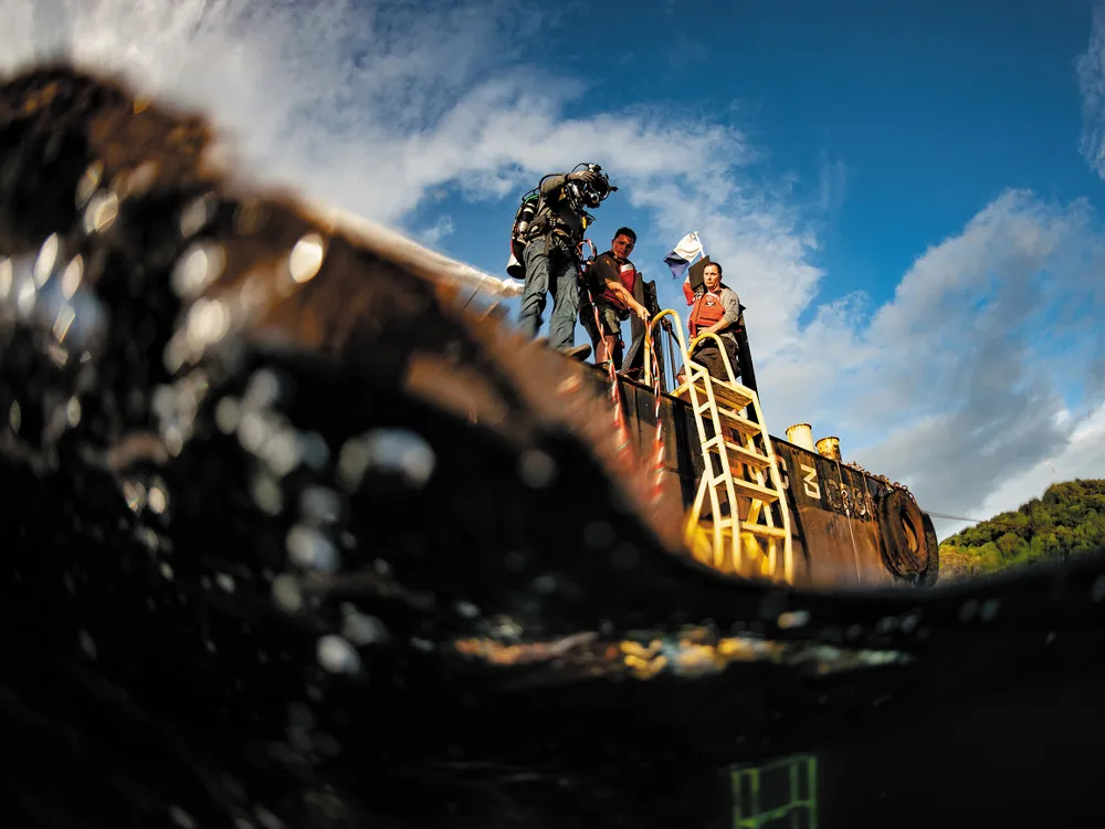 OPENER - A diver prepares to enter the water of Malakal Harbor in Palau, where the plane flown by U.S. Navy pilot Jay Ross Manown Jr. was shot down in September 1944.