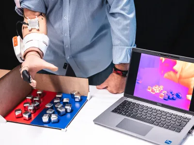 Fabrizio Fidati, a 57-year-old amputee, uses the MiniTouch device with his prosthetic to accurately sort cubes of different temperatures.