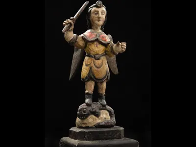 Carved wooden figure of San Miguel en Lucha con el Demonio